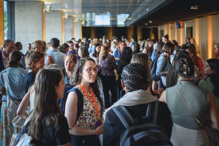 Attendees engage in discussions and networking between sessions during the 1st International Congress on Safe Sport Research held at the Québec City Convention Centre.