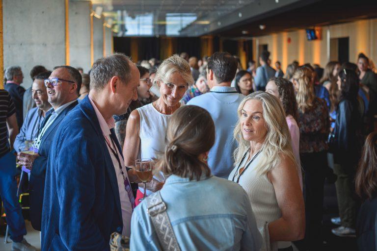 Attendees engage in conversation during a networking break at the 1st International Congress on Safe Sport Research held at the Québec City Convention Centre.