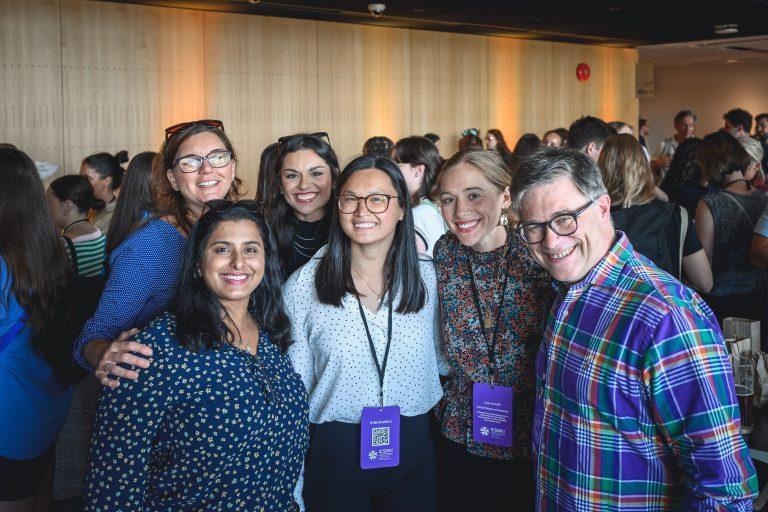 A group of smiling participants gathers for a photo during the 1st International Congress on Safe Sport Research held at the Québec City Convention Centre.