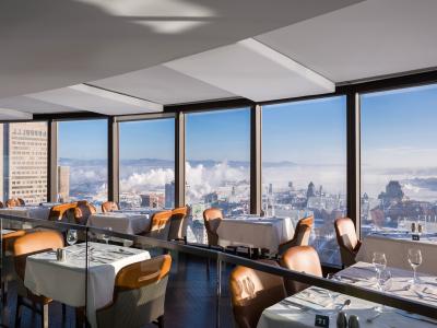 Dining room at Ciel! Bistro-bar with floor-to-ceiling windows overlooking Old Québec, Château Frontenac, and the St. Lawrence River.