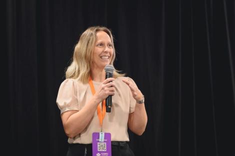 Professor Sylvie Parent, director of the Research Chair in Safety and Integrity in Sports at Université Laval, speaks into a microphone during the 1st International Congress on Safe Sport Research in Québec City.
